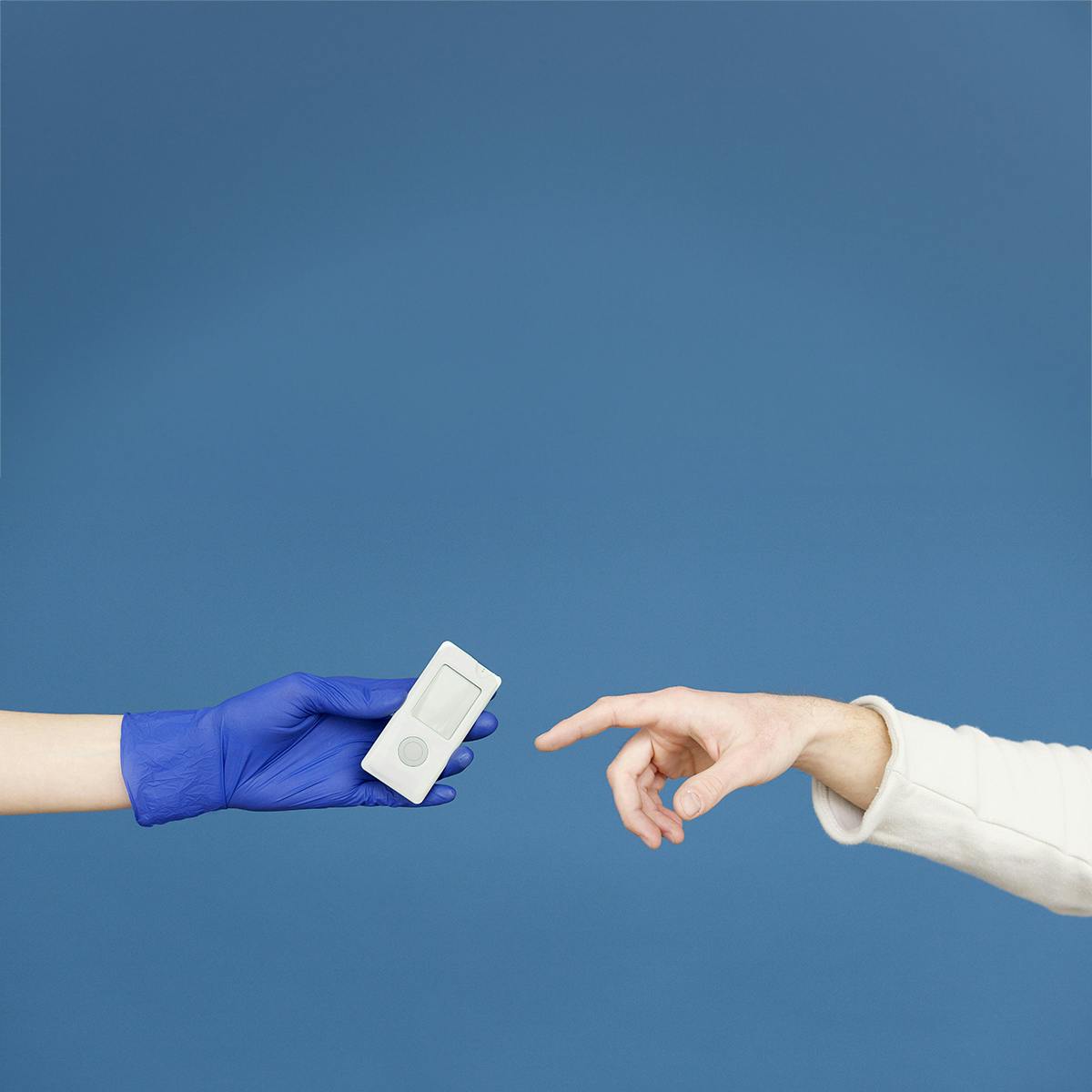 Photo of a gloved hand holding a blood sugar monitoring device reaching out toward the hand of a patient in the style of Michelangelo's "Creation of Adam."