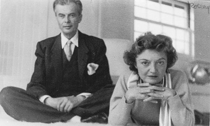 A black-and-white image of Aldous and Laura Huxley; Aldous is seated on the left and Laura is on the right, leaning forward with her head rested on her clapsed hands.