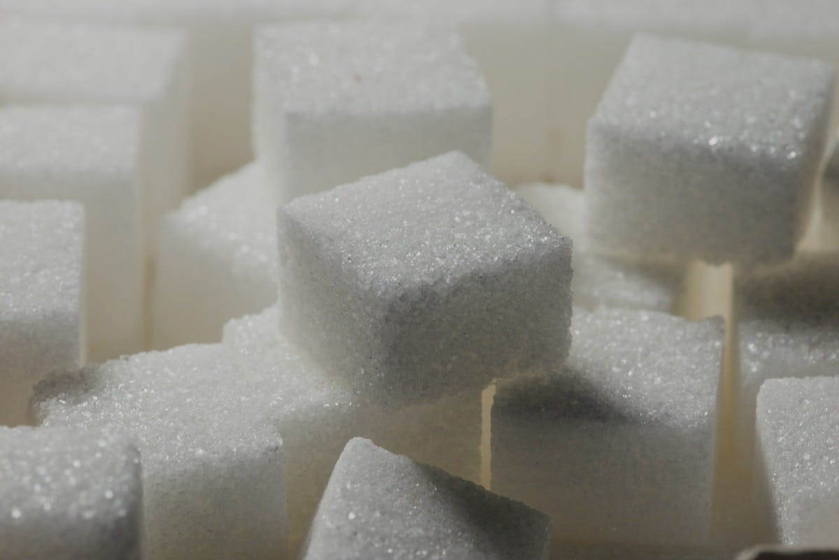 Photo of stacked cubes of non-artificial sugar.