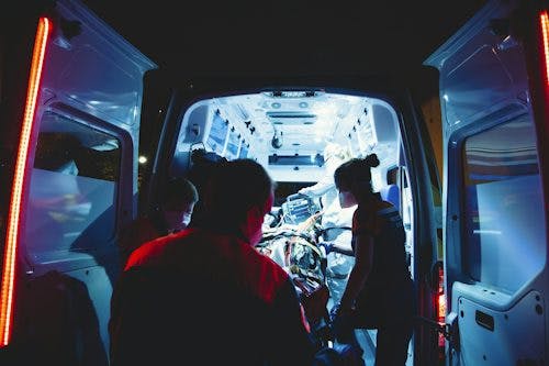 Photo of a person being loaded into an ambulance during a medical emergency.